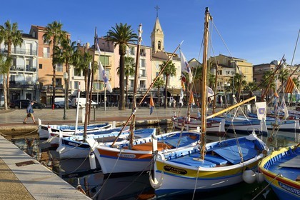 France, Var, Sanary-sur-Mer, traditional fishing boats called pointus in the port and St. Nazaire Church