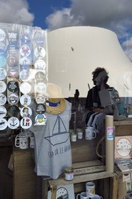 France, Seine Maritime, Le Havre, Downtown rebuilt by Auguste Perret listed as World Heritage by UNESCO, the cultural center called Volcano created by Oscar Niemeyer is reflected in the shop window LoHo The Local sHop