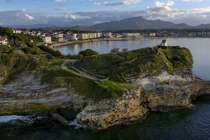 France, Pyrenees Atlantiques, Basque Country coast, Saint-Jean-de-Luz, the coastal path on the GR 8 passing over the flysch cliff of Pointe Sainte-Barbe, a sort of mille-feuille alternating hard and soft rocks, the bay of Saint-Jean-de-Luz and the mountain of La Rhune in the background (aerial view)