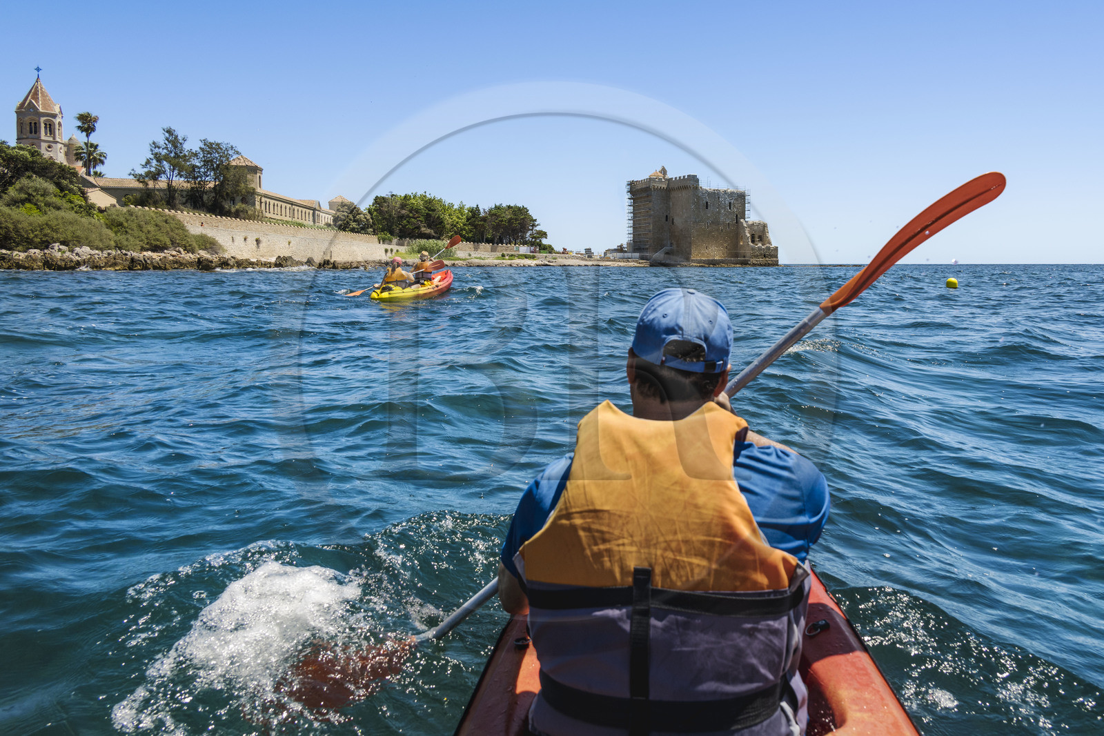 France, Alpes-Maritimes, Cannes, kayaking in the Lerins Islands, tour of the Saint-Honorat island from the south, the church of the Abbey of Lérins and the old fortified monastery in the background