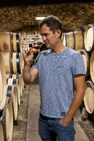 France, Cote d'Or, cultural Landscape of the climates of Burgundy listed as World Heritage by UNESCO, Route des Grands Crus (road of Vintage Wines), vineyard of the Côte de Nuits, Gevrey Chambertin, Domaine Dugat, Bertrand Dugat the cellars under the former Tithe Cellar of the Bishops of Langres where he stores his barrels