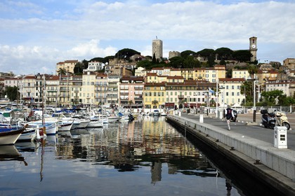 France, Alpes-Maritimes, Cannes, the harbour and the old town in Le Suquet district, at its peak the Tour du Suquet and the steeple of the Notre-Dame-de-l'Esperance church