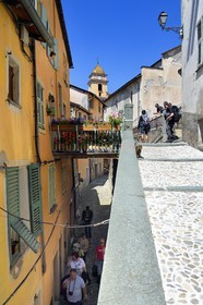 France, Alpes-Maritimes, Roya Valley (Nice hinterland), at the foot of the Mercantour National Park, Saorge, a narrow lane overhung by a pountin (small bridge) and Saint-Sauveur (St. Saviour) church