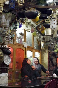 Iran, Isfahan Province, Isfahan, Chai Khaneh Azadegan Tea House and restaurant, woman smoking a water pipe