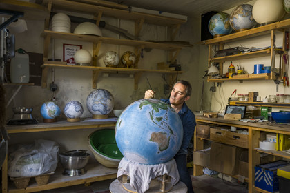 France, Charente, Cognac, Gabriel Gaborel, creator of OrbisTerrae, manufactures handcrafted terrestrial globes painted in watercolor