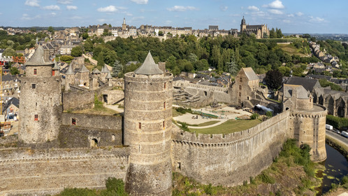 France, Ille-et-Vilaine, Fougeres, 12th century fortified castle and the Saint-Léonard church in the background (aerial view)