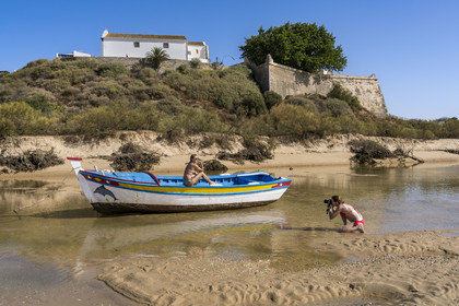Portugal, Algarve, Ria Formosa Nature Park, Tavira, boat in the front of the fortress of the village of Cacela Velha
