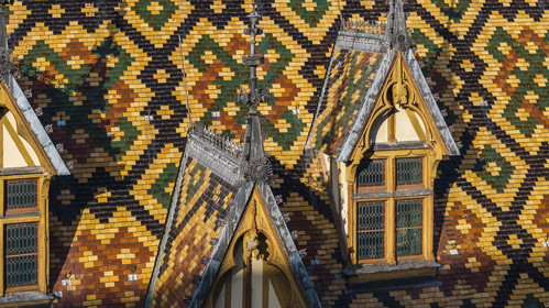 France, Cote d'Or, Beaune, area listed as World Heritage by UNESCO, Hospices de Beaune, Hotel Dieu, the roofs covered with glazed and colored tiles (aerial view)