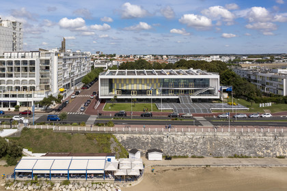France, Charente-Maritime, Royan, the convention center (1957) designed by the architect-urban planner Claude Ferret and the Notre-Dame de Royan church built from 1955 to 1958 by the architect Guillaume Gillet in the background (aerial view)