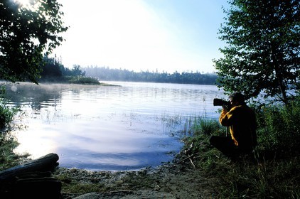 Canada, Quebec Province, La Verendrye Wildlife Reserve, Lake Victoria, a photographer in the early morning