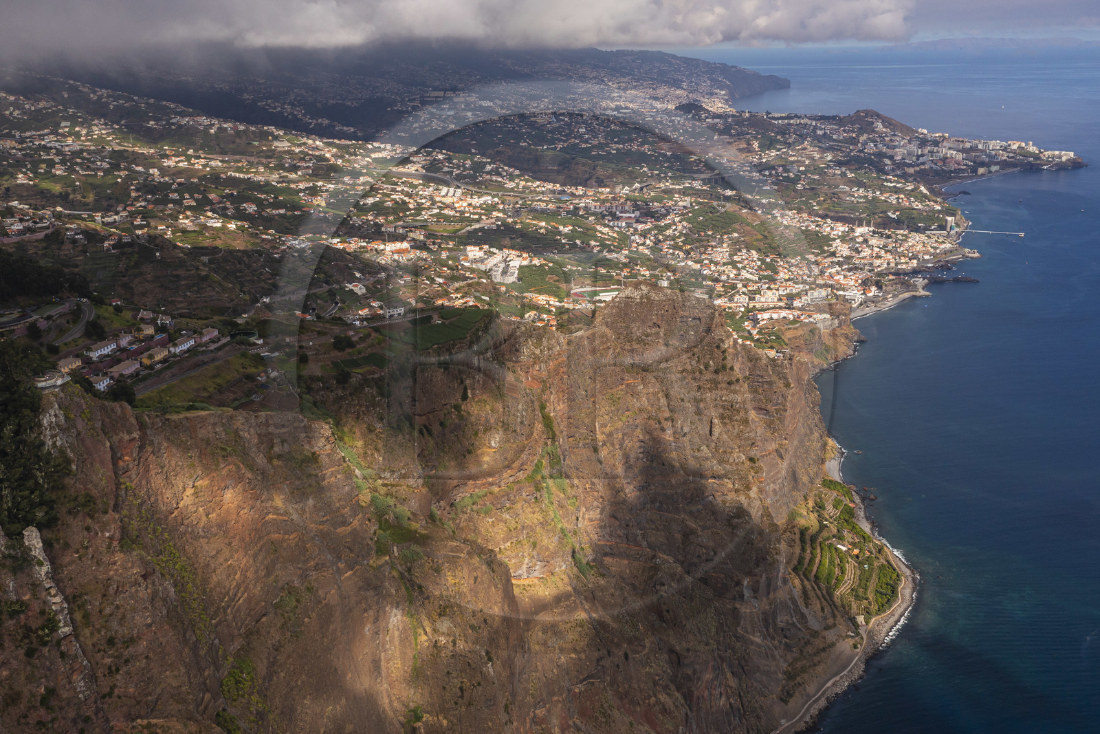 Portugal, Madeira Island, Camara de Lobos, the Cap Girao belvedere, a glass platform overlooking the second highest cliff in the world at 589 meters high, cultivated fields at the foot of the cliff (aerial view)
