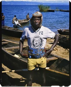 Burundi, Rumonge Province, group of fishermen on Lake Tanganyika, colorful character, that Hutu fisherman nicknamed the madman managed by nearly 40 °C to keep his wool cap on which he hung a German war cross and a Primus beer cap, in the background we perceives the tip of Burton and Speke located in Congo (4x5 reversal film reproduction)