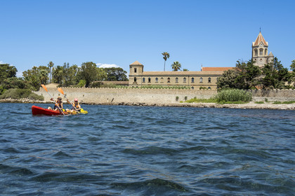 France, Alpes-Maritimes, Cannes, kayaking in the Lerins Islands, tour of the Saint-Honorat island from the south, the church of the Abbey of Lerins in the background