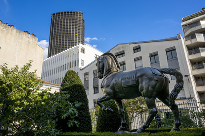 France, Paris, the museum of the sculptor Antoine Bourdelle, sculpture of the horse without a saddle (bronze) in the street garden and the Montparnasse Tower in the background