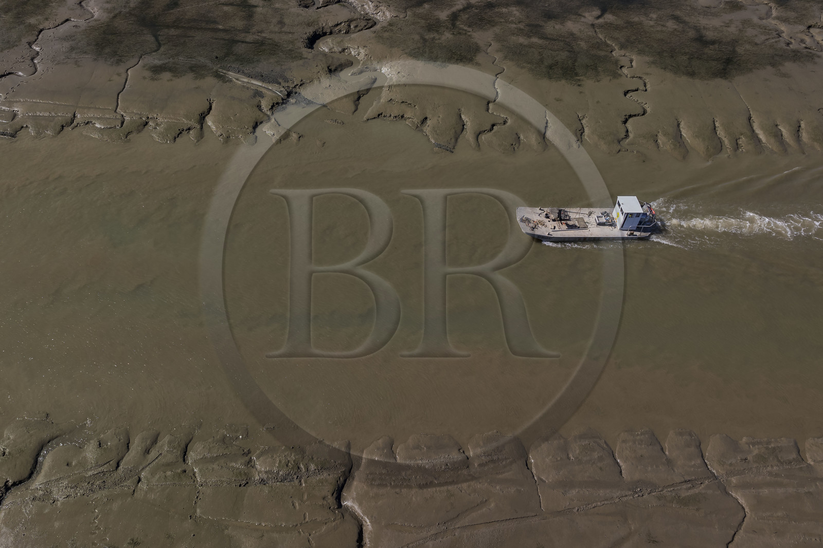 France, Charente Maritime, Oleron island, le Chateau-d'Oleron, oyster boat in the port exit channel at low tide (aerial view)