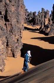 Libya, region of the desert, the Fezzan (Sahara), Tuareg walking between the needles of sandstone of Tassili of Maghidet (Algerian frontier)