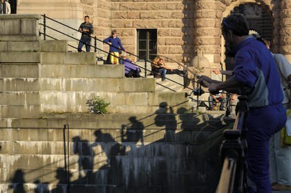 Sweden, Stockholm, Gamla Stan island (old town), fishing on the docks along the Riksgatan street