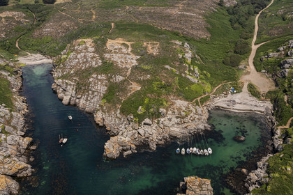 France, Morbihan, Groix Island, Port Saint-Nicolas on the south coast and the small beach of Kerloret in the background on the left (aerial view)