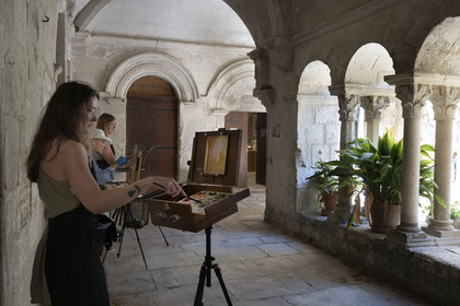 France, Bouches du Rhone, Regional Natural Park of the Alpilles, Saint Remy de Provence, Saint-Paul-de-Mausole monastery, where Van Gogh was interned in 1889-1890, amateur painters who set up their easels in the Romanesque cloister from the 11th and 12th centuries