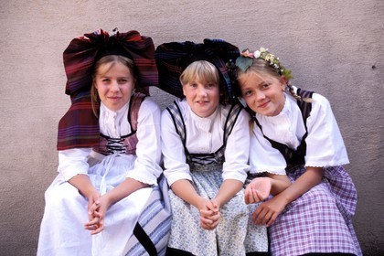 France, Haut Rhin, wine celebration at Eguisheim village, labelled Les Plus Beaux Villages de France (The Most Beautiful Villages of France), girls in Alsatian costumes and headdress