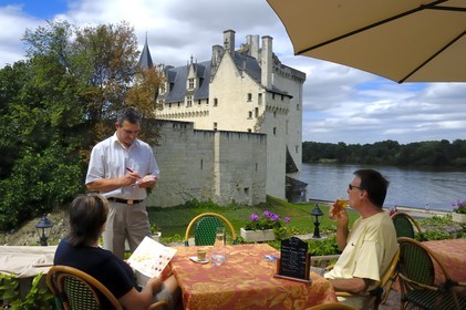 France, Maine et Loire, Loire Valley, Montsoreau, labelled Les Plus Beaux Villages de France (The Most Beautiful Villages of France), Chateau de Montsoreau, castle rebuilt in the 15th century, on the Loire river banks and Le Bussy Hotel terrace