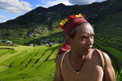 Philippines, Ifugao province, Banaue rice terraces around the village of Batad, listed as World Heritage by UNESCO, the guide Adolpho coated in the traditional Ifugao costume
