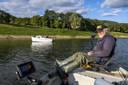 France, Nievre, Regional Natural Park of Morvan, Chaumard, Pannecière lake, Jean-Bernard Dioux, vice-president of the AMC, the Morvan Carnassier Association, fishing on a boat