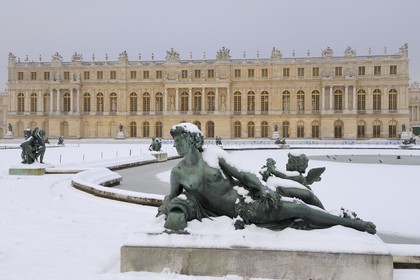 France, Yvelines, snow covered park of the Chateau de Versailles, listed as World Heritage by UNESCO, Parterre d'eau, statue of a affluent of a French river (female)
