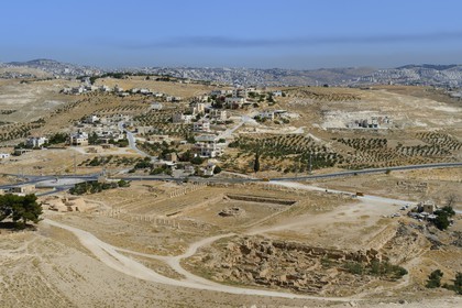 Israel, West Bank, Herodium or Herodion is a volcano-like hill with a truncated cone with a a fortress and palace build by Herod the Great (Herodion National Park), remains of the palace of the lower Herodium and its basin, in the distance Bethlehem