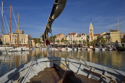 France, Var, Sanary-sur-Mer, traditional fishing boats called pointus in the port and St. Nazaire Church