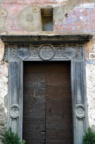 France, Alpes-Maritimes, Roya Valley (Nice hinterland), at the foot of the Mercantour National Park, Tende, former home of René of Savoy called the Great Bastard of Savoy, green slate lintel engraved with the monogram IHS meaning Jesus savior of men that keeps evil spirits away from the house