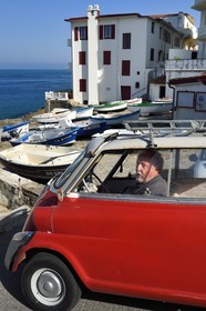 France, Pyrenees Atlantiques, Basque Country coast, Guethary, French journalist, writer and director Alain Gardinier driving his BMW Isetta