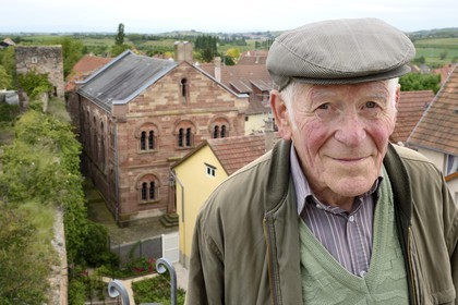France, Bas Rhin, Westhoffen, Roger Cahn, the last Jew of Westhoffen born in 1930, the former synagogue in the background
