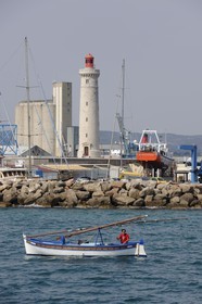 France, Herault, Sete, Mole Saint Louis, lighthouse near the careening harbour and the industrial and commercial port in the back