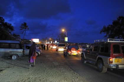 Tanzania, Dar es-Salaam, there is still lot of people at Coco Beach at dusk on Sunday, traffic jam