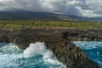 France, Reunion island (French overseas department), L'Etang Salé les Bains, the coast between Le Gouffre and the Etang du Gol (Gol Pond), black basaltic rocks of volcanic origin tormented by the ocean (aerial view)