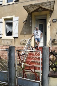 France, Moselle, Petite Rosselle, former workers housing district of the industrial city created by the Wendel family for coal mines, the former miner Raphael Alcudia Gomez in front of his miner's house dating from 1908