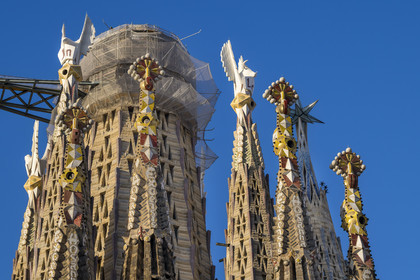 Spain, Catalonia, Barcelona, Eixample district, Sagrada Familia basilica by Catalan modernist architect Antoni Gaudi, listed as a UNESCO World Heritage Site, bell towers topped with pinnacles surrounding the central ciborium and the future central tower