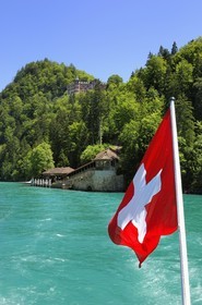 Switzerland, Canton of Bern, Bernese Oberland, Interlaken, Lake Brienz (Brienzer See), Luxury Hotel in Giessbach and swiss flag
