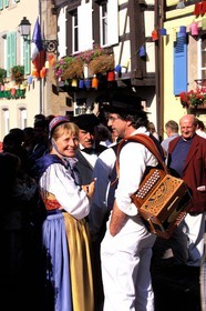 France, Haut Rhin, Eguisheim village, labelled Les Plus Beaux Villages de France (The Most Beautiful Villages of France), wine celebration, Alsatian couple in traditional costume