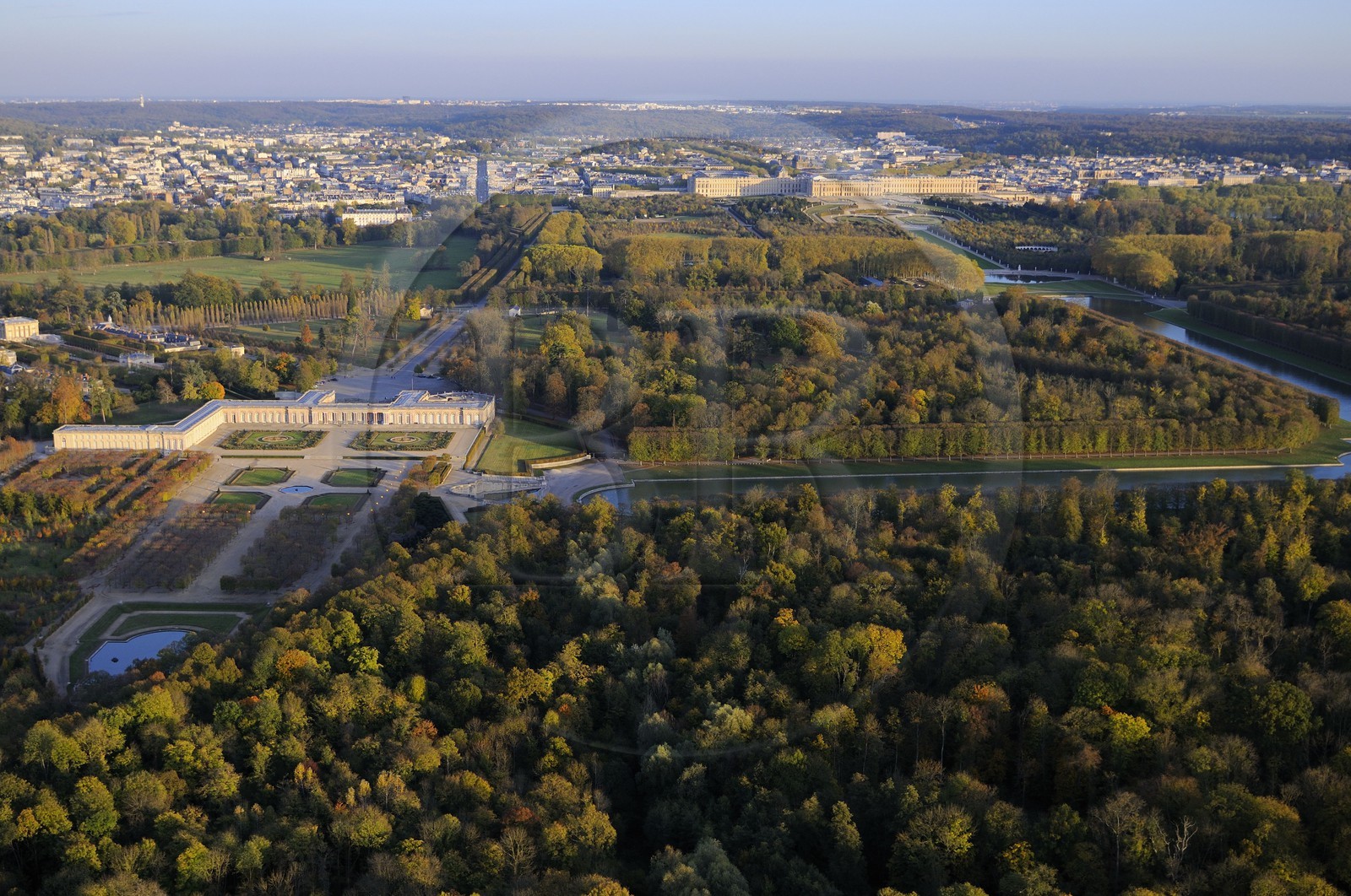 France, Yvelines, Chateau de Versailles Park, listed as World Heritage by UNESCO, the Grand Trianon in the foreground and the castle in the background (aerial view)