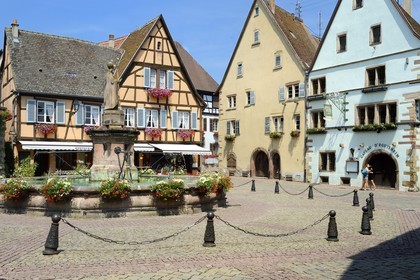 France, Haut Rhin, Eguisheim, labelled Les Plus Beaux Villages de France (The Most Beautiful Villages of France), Castle square, the fountain topped by a statue of Pope Leo IX native of the village