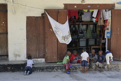 Tanzania, Zanzibar Archipelago, Unguja island (Zanzibar), Stone Town, listed as World Heritage by UNESCO, kids playing in front of a shop in the old city in the Shangani neighborhood