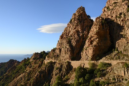 France, Corse du Sud, Golfe de Porto, listed as World Heritage by UNESCO,  the Creeks of Piana (Calanches de Piana) with pink granite rocks and the D81 road between Porto and Cargese