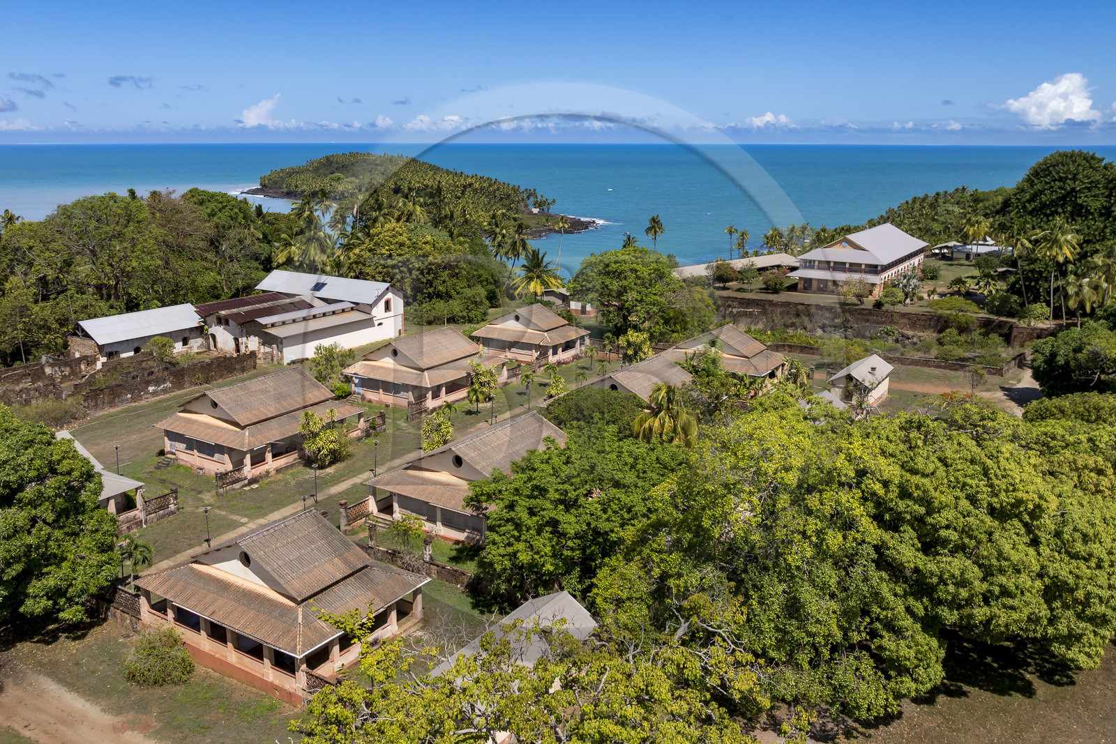 France, French Guiana, Kourou, Salvation Islands (Iles du Salut), Royal Island, which housed the administration, chapel and hospital of the penal colony, as well as the family accommodations of the guards in the foreground, Devil's Island in the background (aerial view)