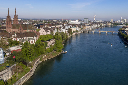 Switzerland, Basel, the left bank of the Rhine, the Minster or Protestant Cathedral of Our Lady of Basel (Munster) overlooking the Rhine, the Mittlere Brucke bridge in the background (aerial view)