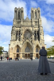France, Marne, Reims, Notre-Dame de Reims cathedral, listed as World Heritage by UNESCO, the western facade and monk on the square