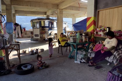Philippines, Ifugao province, Banaue town, inside the habitat of a family housed in a building under construction, a jeepney is parked in the back