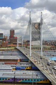 South Africa, Gauteng Province, Johannesburg, Nelson Mandela bridge over train carriages at Park Station and Johannesburg CBD (Central Business District) seen from the district of Braamfontein