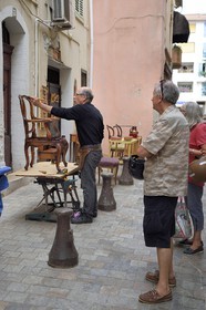 France, Alpes-Maritimes, Cannes, the old town in Le Suquet district, woodworker repairing a chair in the rue de la misericorde